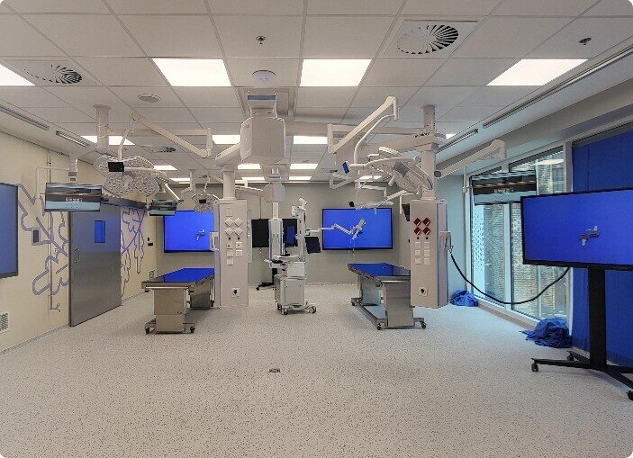 Modern hybrid operating room with integrated displays and imaging equipment